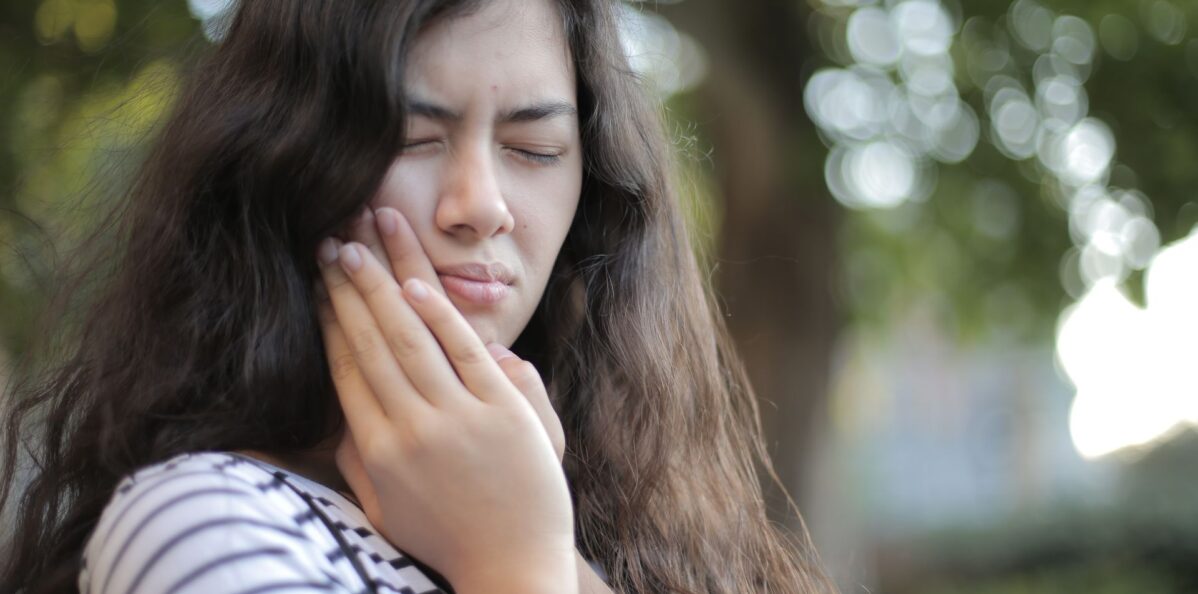 Dentist in Langley providing emergency dental care to a patient in pain