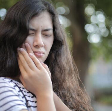 Dentist in Langley providing emergency dental care to a patient in pain